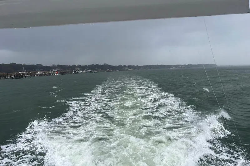 Our Trade II Yacht Photos Pics Wake of Ocean Yachts 48 Super Sport, 1996, cruising on a cloudy day.