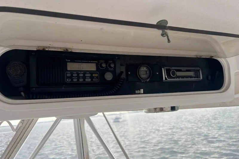 Our Trade II Yacht Photos Pics 1996 Ocean Yachts 48 Super Sport radio and control panel on a boat.