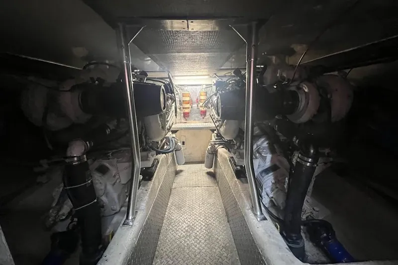 Our Trade II Yacht Photos Pics Engine room of 1996 Ocean Yachts 48 Super Sport, showcasing dual engines and mechanical components.