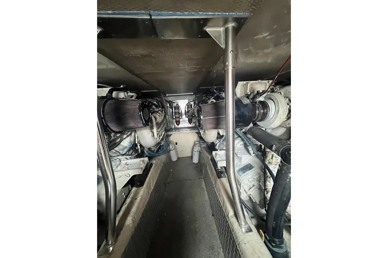 Our Trade II Yacht Photos Pics Engine room of 1996 Ocean Yachts 48 Super Sport, showcasing dual engines and mechanical components.