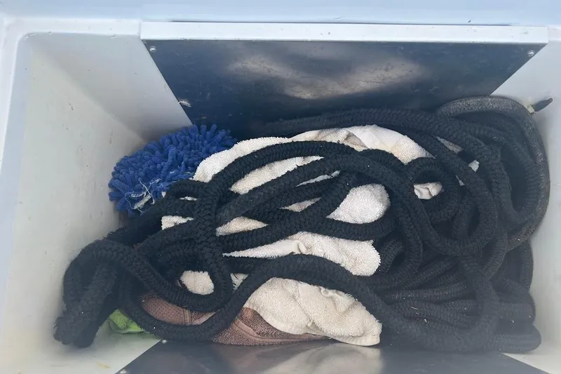 Our Trade II Yacht Photos Pics Storage compartment with ropes and towels on a 1996 Ocean Yachts 48 Super Sport.