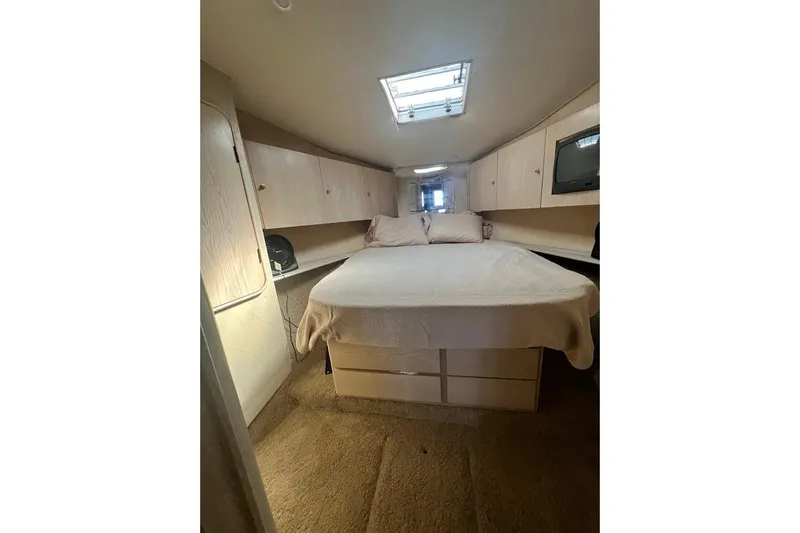 Our Trade II Yacht Photos Pics Interior cabin of 1996 Ocean Yachts 48 Super Sport with bed and storage.