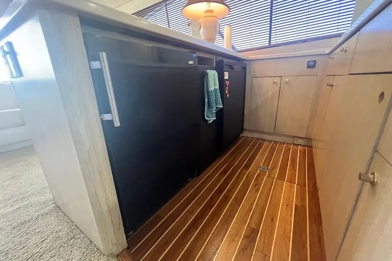 Our Trade II Yacht Photos Pics Interior of 1996 Ocean Yachts 48 Super Sport, featuring sleek kitchen cabinetry and wood flooring.