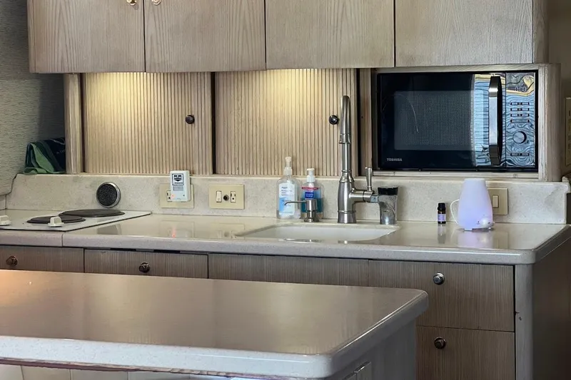 Our Trade II Yacht Photos Pics Kitchen area of a 1996 Ocean Yachts 48 Super Sport with microwave and sink.
