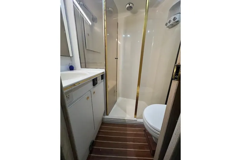 Our Trade II Yacht Photos Pics Bathroom interior of 1996 Ocean Yachts 48 Super Sport with shower and wooden flooring.