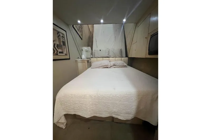 Our Trade II Yacht Photos Pics Cozy bedroom in 1996 Ocean Yachts 48 Super Sport with elegant decor and soft lighting.
