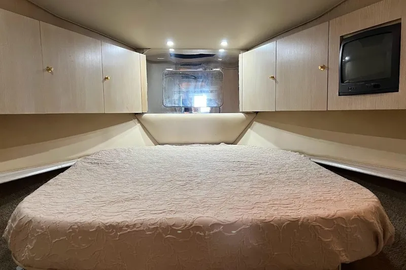 Our Trade II Yacht Photos Pics Luxurious cabin interior of 1996 Ocean Yachts 48 Super Sport with cozy bed and storage.