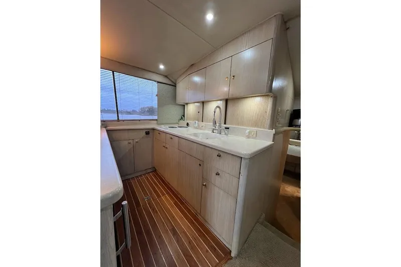 Our Trade II Yacht Photos Pics Interior of 1996 Ocean Yachts 48 Super Sport, featuring a modern kitchen with wood flooring.