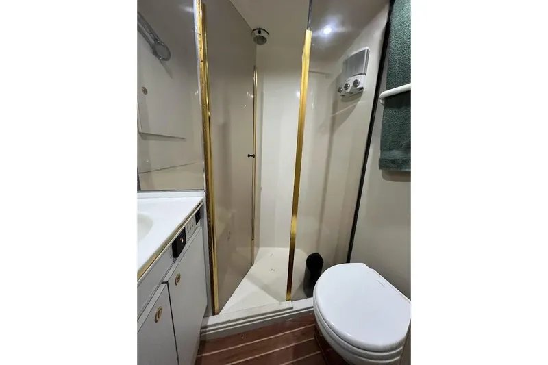 Our Trade II Yacht Photos Pics Bathroom of 1996 Ocean Yachts 48 Super Sport with shower, toilet, and sink.