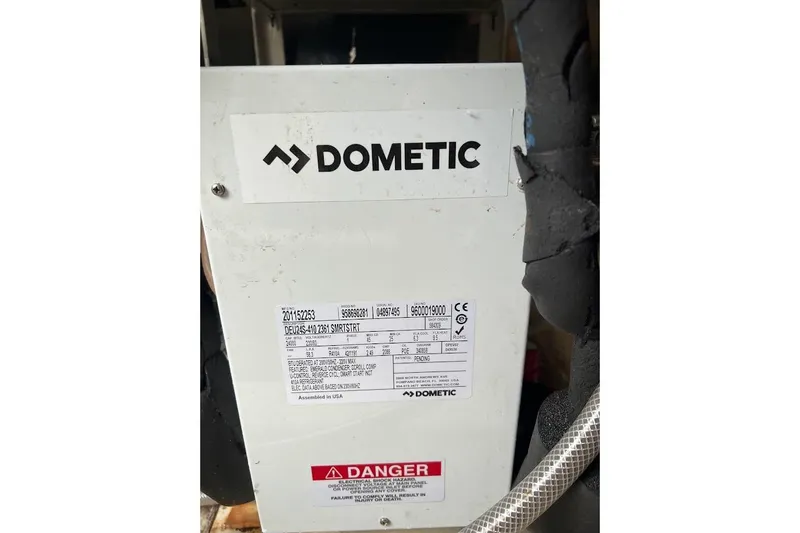 Our Trade II Yacht Photos Pics Dometic unit on 1996 Ocean Yachts 48 Super Sport, featuring warning label.