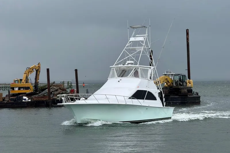 Our Trade II Yacht Photos Pics 1996 Ocean Yachts 48 Super Sport cruising near construction site with excavators.