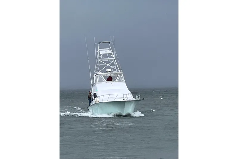 Our Trade II Yacht Photos Pics Ocean Yachts 1996 48 Super Sport navigating through choppy waters.