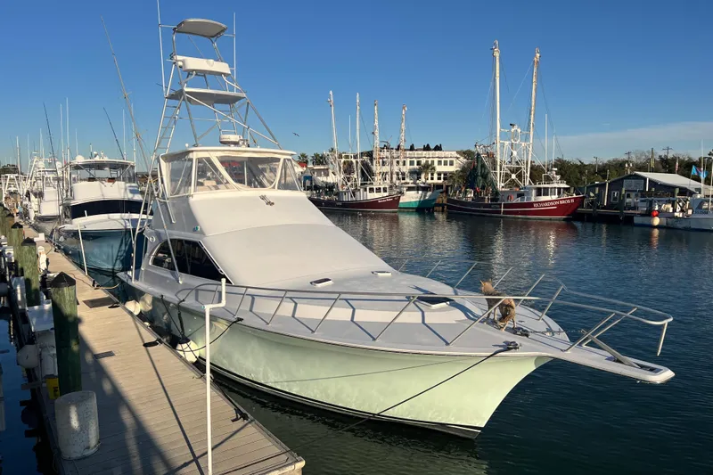 Our Trade II Yacht Photos Pics 1996 Ocean Yachts 48 Super Sport docked at marina, clear sky background.