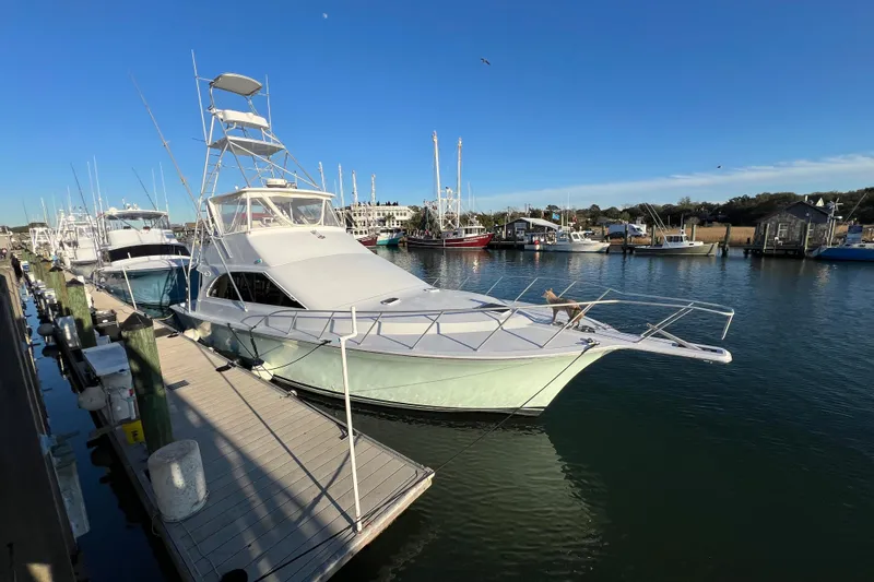 Our Trade II Yacht Photos Pics 1996 Ocean Yachts 48 Super Sport docked in a marina under clear blue skies.