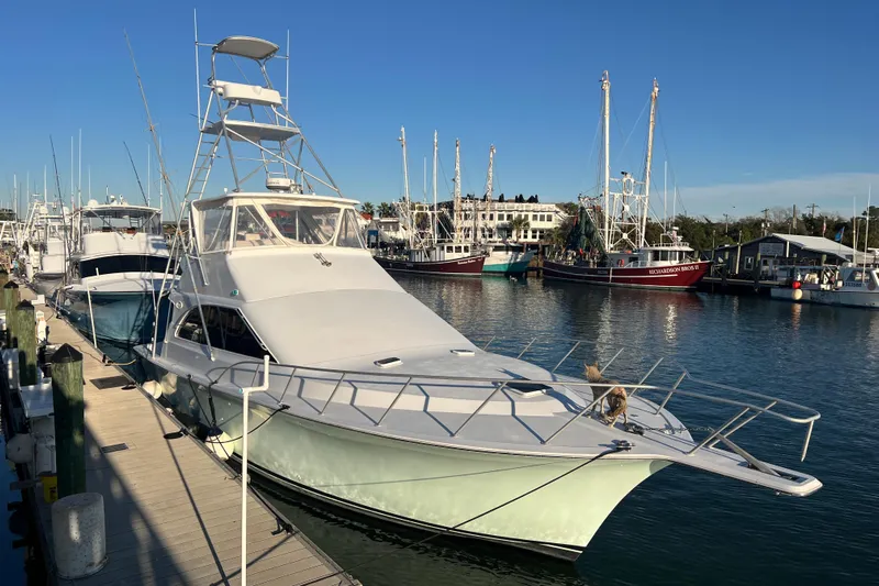 Our Trade II Yacht Photos Pics 1996 Ocean Yachts 48 Super Sport docked at a marina under clear blue skies.
