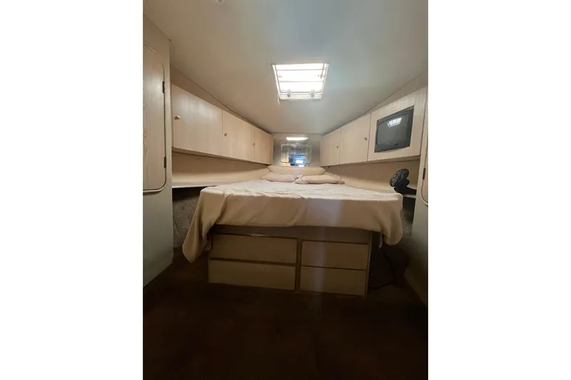 Our Trade II Yacht Photos Pics 1996 Ocean Yachts 48 Super Sport cabin interior with bed and storage.