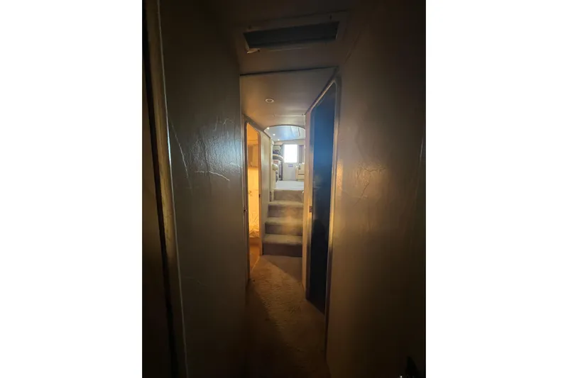 Our Trade II Yacht Photos Pics Hallway inside 1996 Ocean Yachts 48 Super Sport, leading to a sunlit cabin.