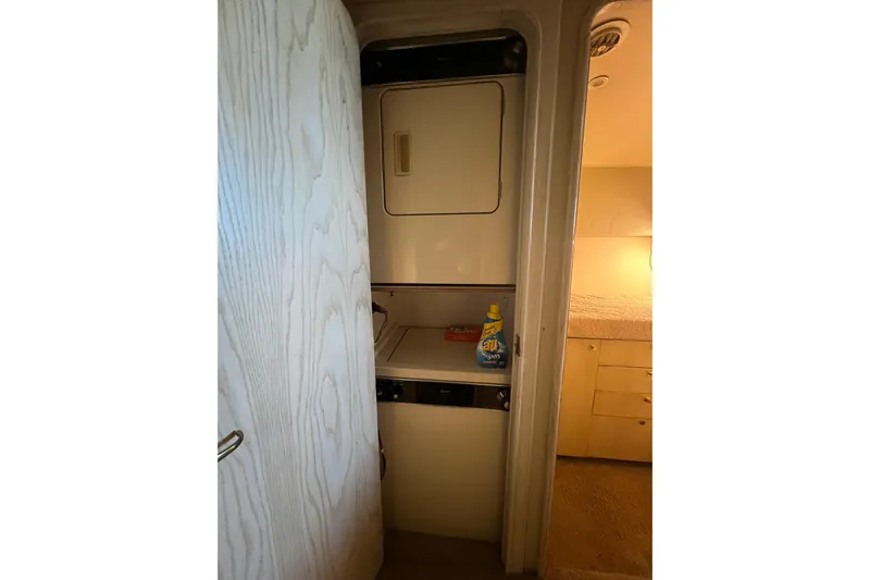 Our Trade II Yacht Photos Pics Laundry area inside 1996 Ocean Yachts 48 Super Sport, featuring a compact washer and dryer.