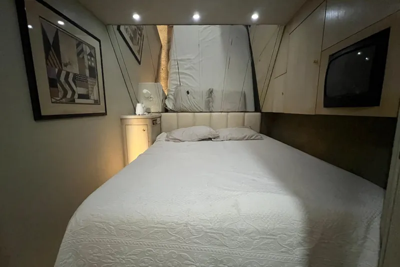 Our Trade II Yacht Photos Pics Cozy bedroom interior of 1996 Ocean Yachts 48 Super Sport with elegant decor.
