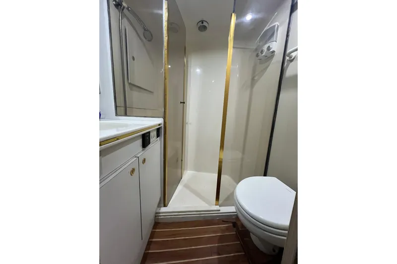 Our Trade II Yacht Photos Pics Bathroom interior of 1996 Ocean Yachts 48 Super Sport with shower and toilet.