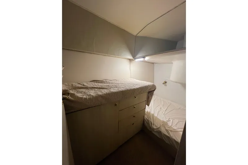 Our Trade II Yacht Photos Pics Cozy cabin interior of 1996 Ocean Yachts 48 Super Sport with bed and storage.