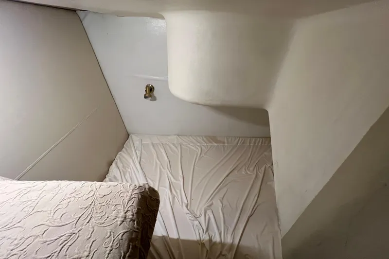 Our Trade II Yacht Photos Pics Interior cabin of 1996 Ocean Yachts 48 Super Sport, featuring a simple bed setup.