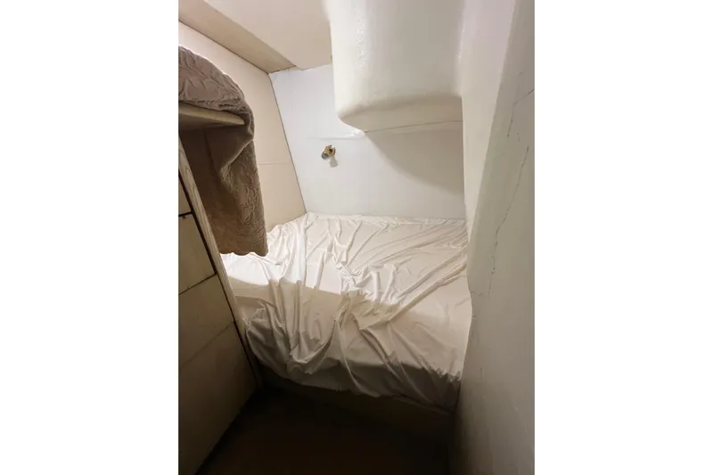 Our Trade II Yacht Photos Pics Cozy cabin interior of 1996 Ocean Yachts 48 Super Sport with bed and storage.