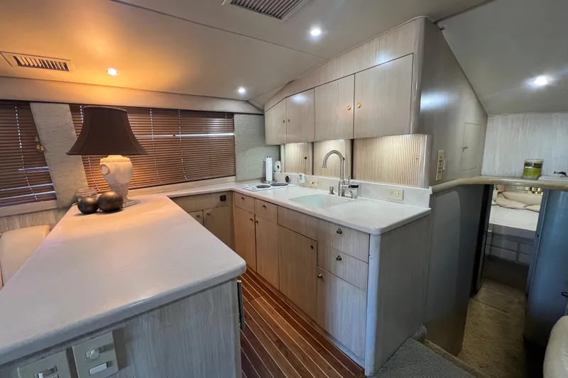 Our Trade II Yacht Photos Pics Luxurious 1996 Ocean Yachts 48 Super Sport interior with modern kitchen and elegant lighting.