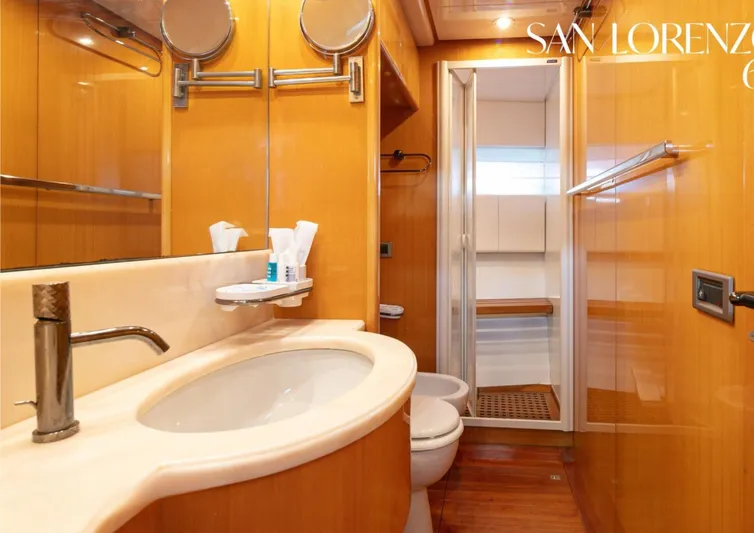  Yacht Photos Pics Luxurious bathroom in 1998 Sanlorenzo 62 yacht with modern fixtures and wooden accents.