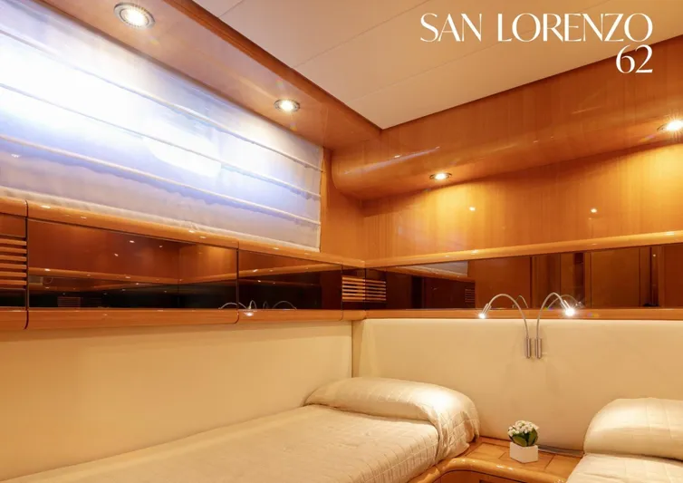  Yacht Photos Pics Luxurious cabin interior of 1998 Sanlorenzo 62 yacht with elegant wood paneling.