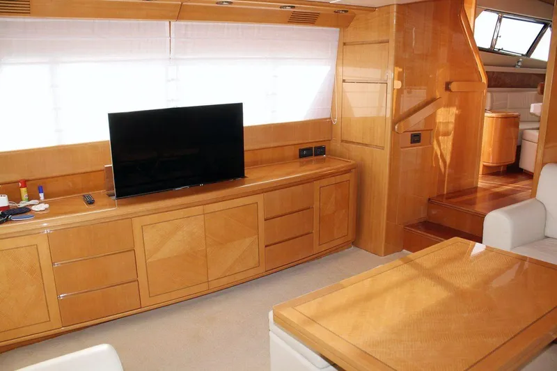  Yacht Photos Pics Luxurious interior of 1998 Sanlorenzo 62 yacht with modern furnishings and TV.