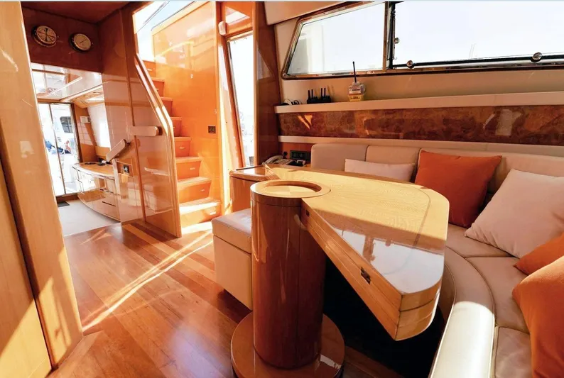  Yacht Photos Pics Luxurious interior of a 1998 Sanlorenzo 62 yacht with elegant wood finishes and cozy seating.