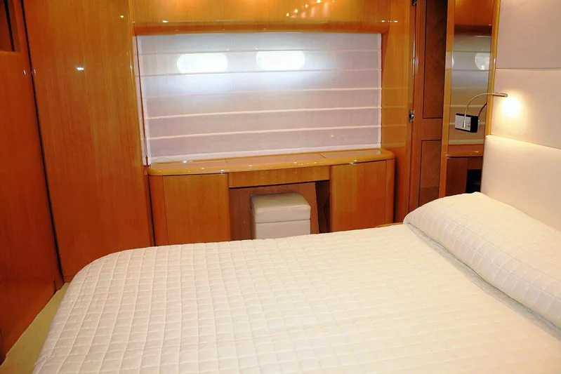  Yacht Photos Pics Luxurious cabin interior of 1998 Sanlorenzo 62 yacht with elegant wood finish.