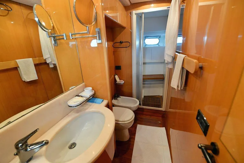  Yacht Photos Pics Luxurious bathroom in 1998 Sanlorenzo 62 yacht with modern fixtures and wooden accents.