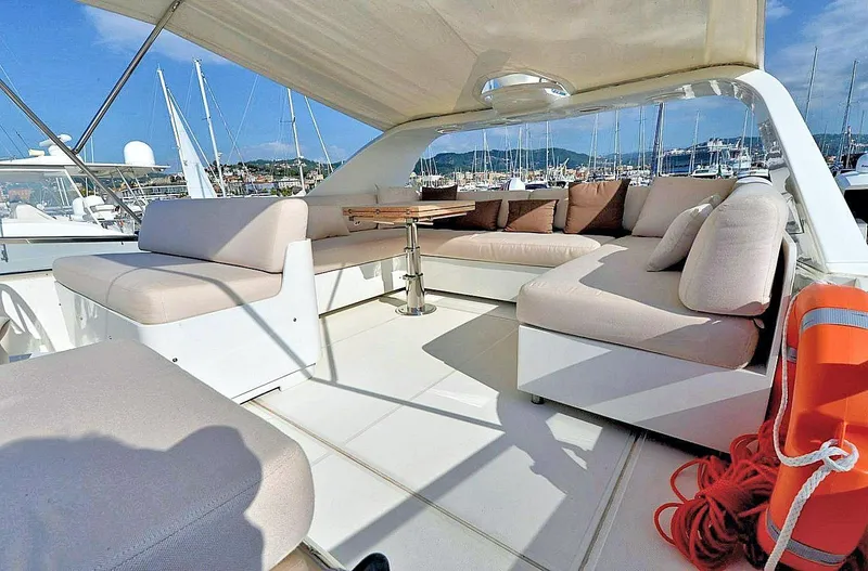  Yacht Photos Pics Luxurious 1998 Sanlorenzo 62 yacht with spacious outdoor seating and marina view.