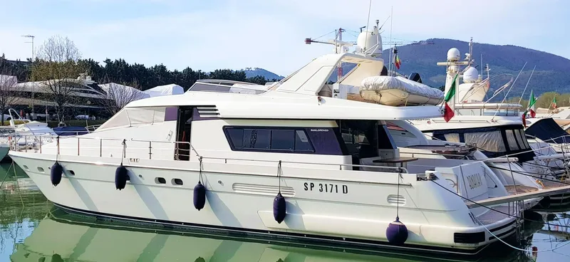  Yacht Photos Pics 1998 Sanlorenzo 62 yacht docked in a marina, side view.