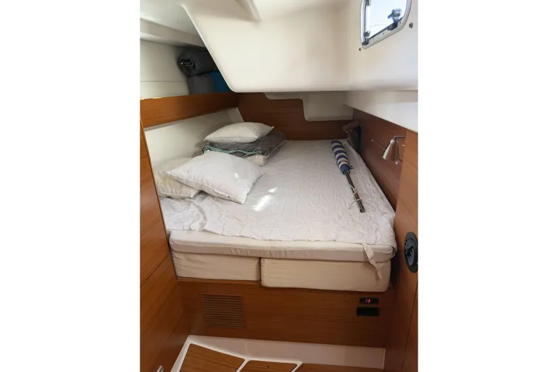Heartbreaker Yacht Photos Pics Cozy cabin interior of 2011 X-Yachts X-55 with wooden finish and comfortable bedding.