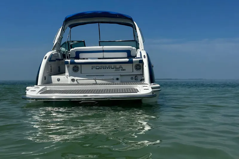  Yacht Photos Pics 2017 Formula 350 Crossover Bowrider on calm water, rear view, clear blue sky.