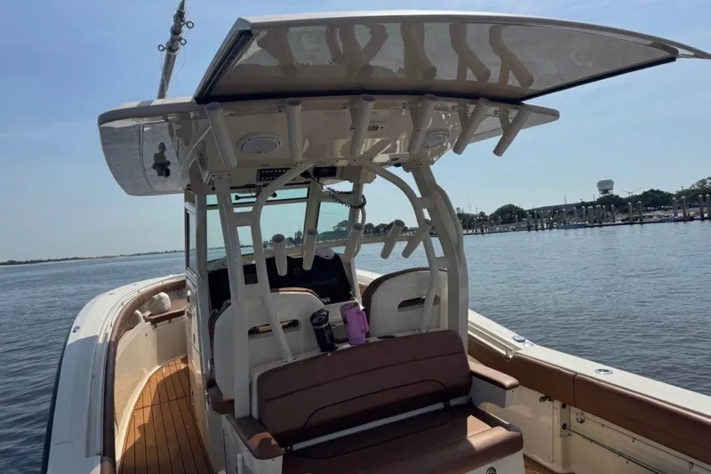  Yacht Photos Pics 2017 Scout 350 LXF boat on calm water, featuring sleek design and spacious deck.