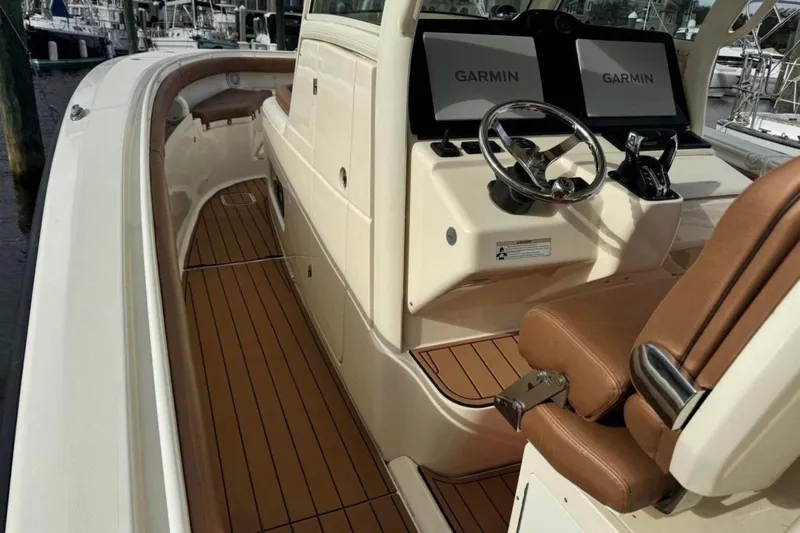  Yacht Photos Pics 2017 Scout 350 LXF boat interior with Garmin displays and brown seating.