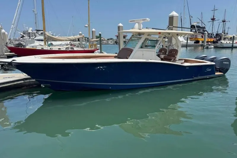  Yacht Photos Pics 2017 Scout 350 LXF boat docked in marina with clear blue water.