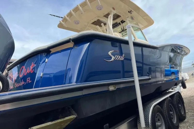  Yacht Photos Pics 2017 Scout 350 LXF boat on trailer, blue hull, side view.