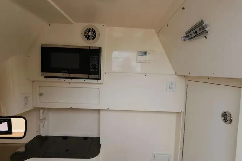  Yacht Photos Pics Interior of 2017 Scout 350 LXF boat with microwave and storage compartments.