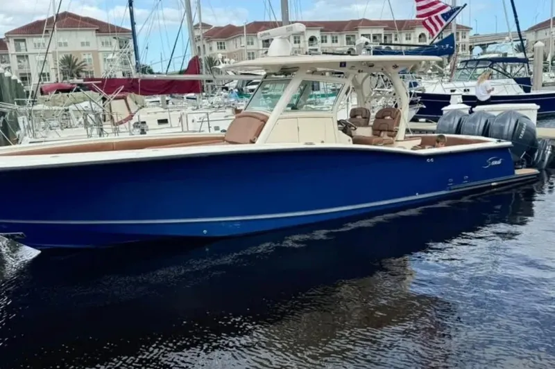  Yacht Photos Pics 2017 Scout 350 LXF boat docked in marina, featuring sleek blue design and twin engines.