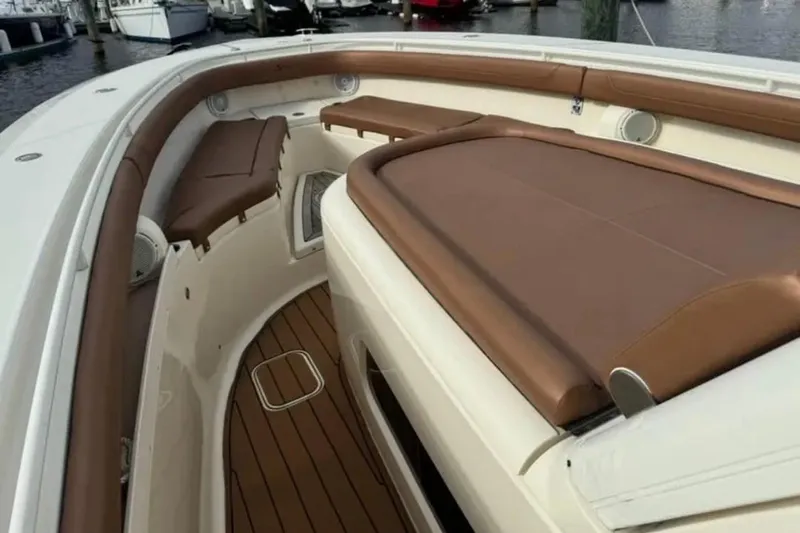  Yacht Photos Pics 2017 Scout 350 LXF boat interior with brown leather seating and wood flooring.