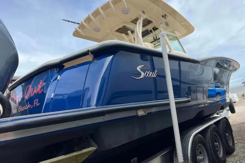 Yacht Photos Pics 2017 Scout 350 LXF boat with blue hull, parked on a trailer.