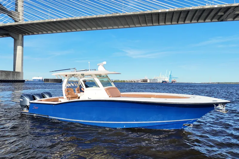  Yacht Photos Pics 2017 Scout 350 LXF boat on water under bridge, clear sky background.