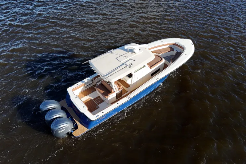  Yacht Photos Pics 2017 Scout 350 LXF boat cruising on open water, featuring triple Yamaha engines.