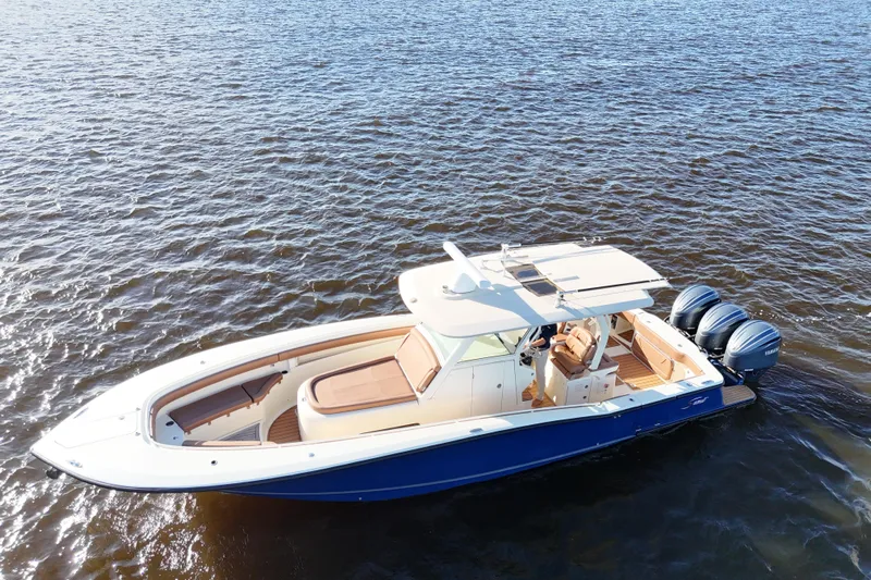  Yacht Photos Pics 2017 Scout 350 LXF boat on water, featuring triple outboard engines.