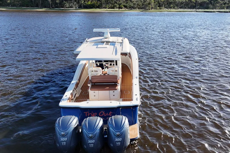  Yacht Photos Pics 2017 Scout 350 LXF boat with triple engines on a calm lake.